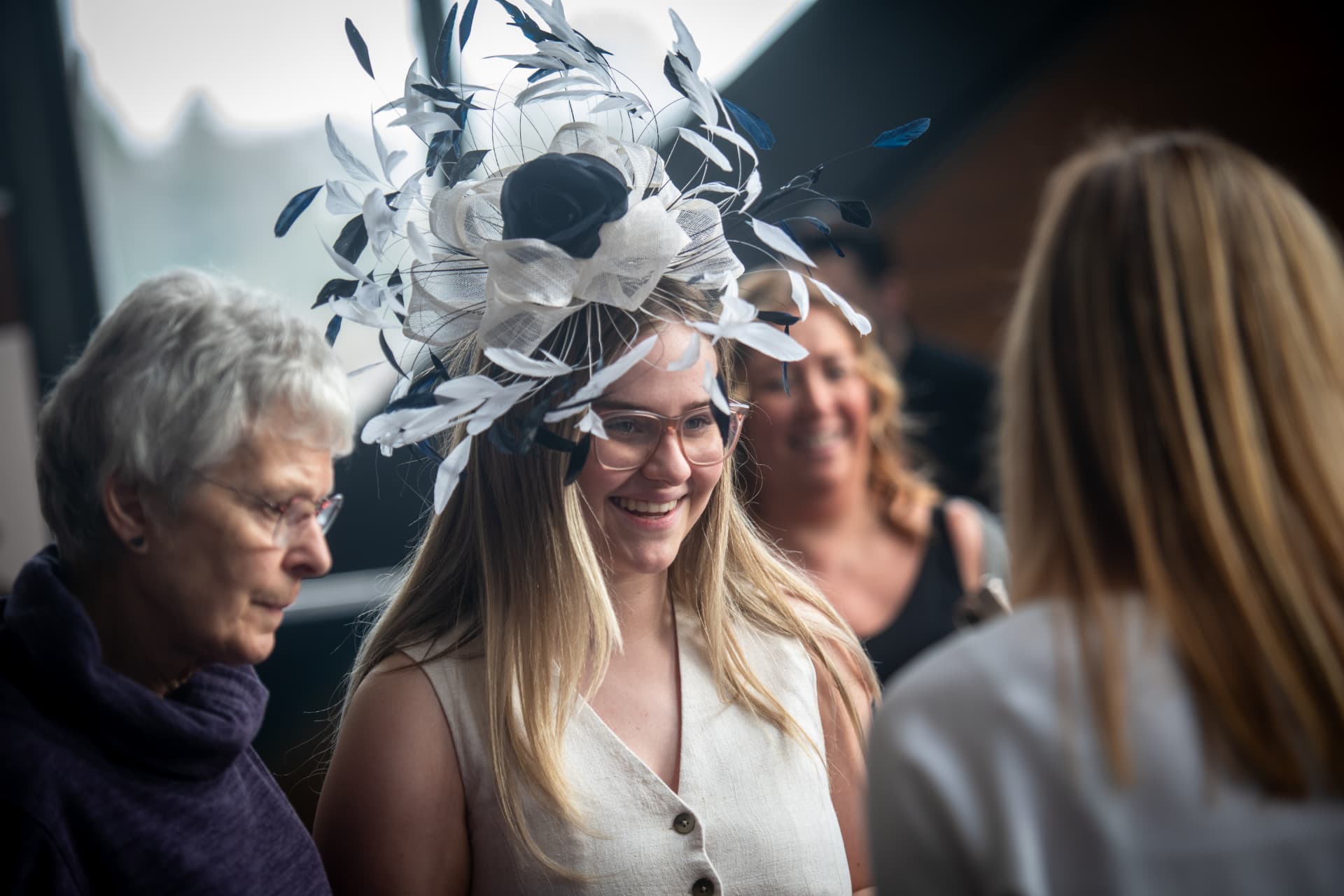 A guest wearing a feathered fascinator at the fair