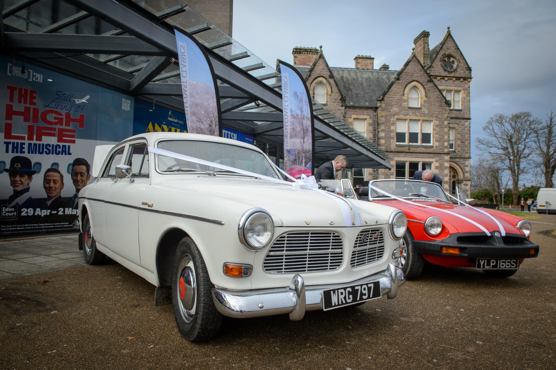 Wedding cars decorated with ribbons outside Eden Court, Inverness